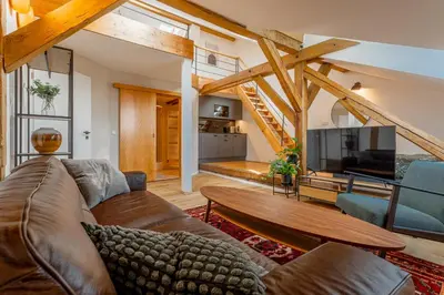 a living room with a couch and a tv at Parkview Studio in Prague