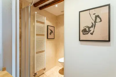 a bathroom with a toilet and a picture on the wall at Parkview Studio in Prague