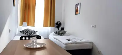 a small room with a table and a bed at Zlatý pokoj v centru Prahy B1 in Prague