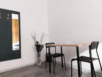 a dining room table with two chairs and a mirror at Zlatý pokoj v centru Prahy B1 in Prague