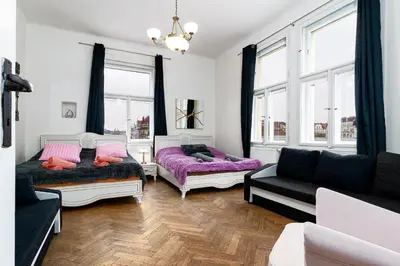 a living room with two beds and a couch at Victory Castle Suite in Prague