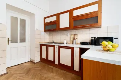 a kitchen with a bowl of fruit on the counter at Victory Castle Suite in Prague