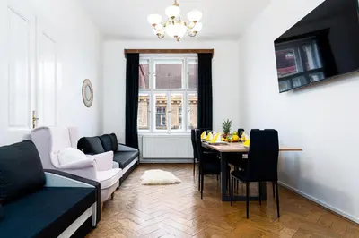 a living room with a table and a couch at Victory Castle Suite in Prague