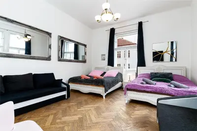 a living room with two beds and a couch at Victory Castle Suite in Prague