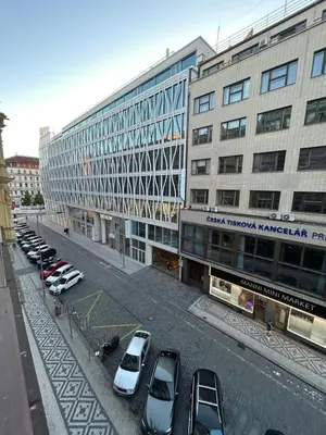 a parking lot with cars parked in front of a building at New apartment near Wenceslas Square in Prague