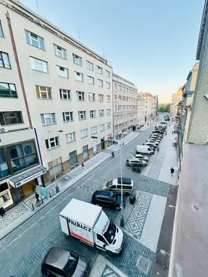 a city street with parked cars and buildings at New apartment near Wenceslas Square in Prague