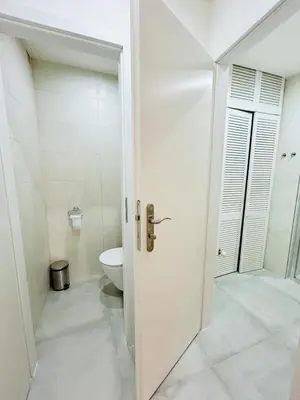 a white bathroom with a toilet and a shower at New apartment near Wenceslas Square in Prague