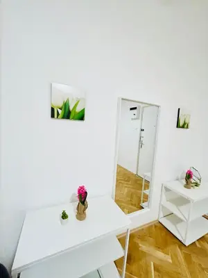 a white dressing table and a mirror in a room at New apartment near Wenceslas Square in Prague