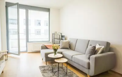 a living room with a couch and a table at Waltrovka One bed room apartment in Prague