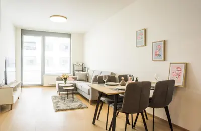 a living room with a table and a couch at Waltrovka One bed room apartment in Prague
