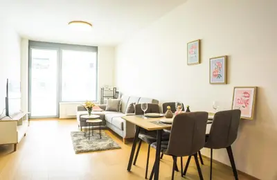 a living room with a table and a couch at Waltrovka One bed room apartment in Prague