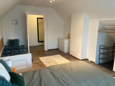 a bedroom with a bed and a bunk room at Domek Jiráskova in Dobříš