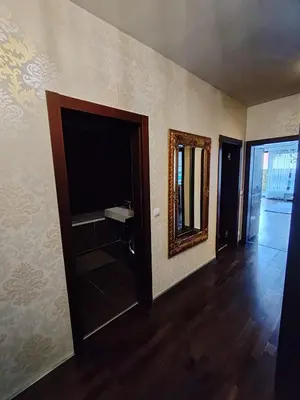 a living room with a flat screen tv and a mirror at Old Brewery Terrace Apartment in Prague
