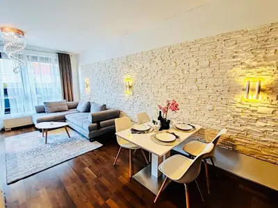 a living room with a couch and a table and chairs at Old Brewery Terrace Apartment in Prague