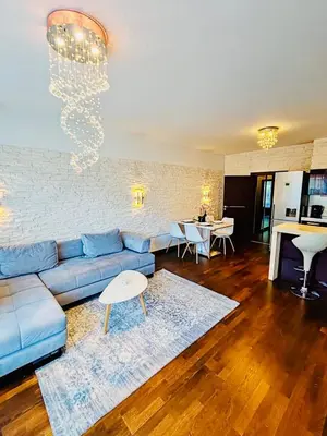 a living room with a blue couch and a table at Old Brewery Terrace Apartment in Prague