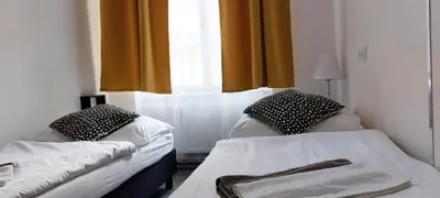 two beds in a room with a window at B2 Dvoulůžkový pokoj centrum Prahy in Prague