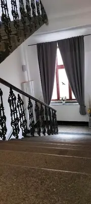 a room with a staircase and a window with curtains at B2 Dvoulůžkový pokoj centrum Prahy in Prague