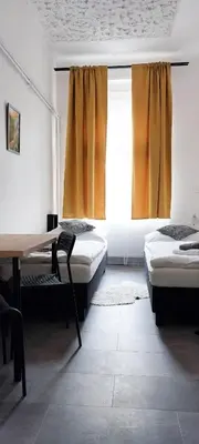 a bedroom with two beds and a desk and a window at B2 Dvoulůžkový pokoj centrum Prahy in Prague