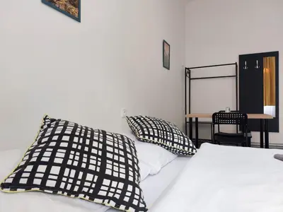 a bedroom with a bed with black and white pillows at Fantastický pokoj v Praze na Letné B3 in Prague