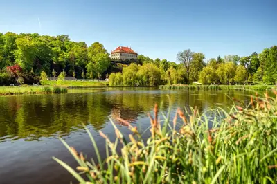 a view of a lake with a building in the background at Fantastický pokoj v Praze na Letné B3 in Prague
