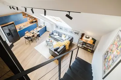an overhead view of a living room and dining room at Prague Days - Two-Bedroom Maisonette with AC and Terrace with Grill in Vinohrady in Prague