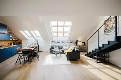a living room with a couch and a table at Prague Days - Two-Bedroom Maisonette with AC and Terrace with Grill in Vinohrady in Prague