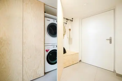 a laundry room with a washer and dryer at Prague Days - Two-Bedroom Maisonette with AC and Terrace with Grill in Vinohrady in Prague