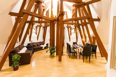 a living room with a table and chairs at Kozi Loft Residence Prague Old Town in Prague