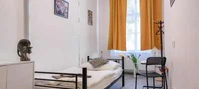 a room with a bed and a chair and a window at Single room B5 centre of Prague in Prague