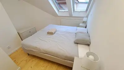 a bed in a small room with a window at Prague Urban Oasis Loft in Prague