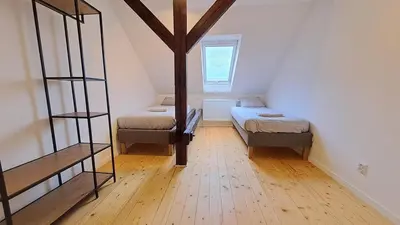 a room with two beds and a ladder in it at Prague Urban Oasis Loft in Prague