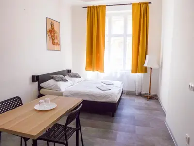 a small room with a bed and a table at Soukromý pokoj v centru C2 in Prague