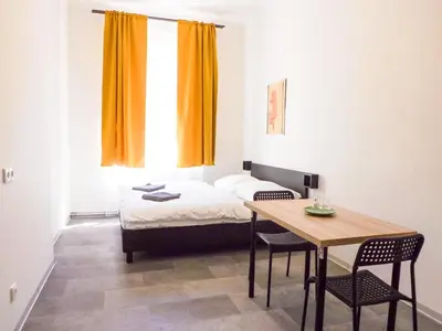 a room with a bed and a table with chairs at Soukromý pokoj C3 v centru Prahy in Prague