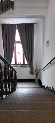 a staircase with curtains and a window in a building at Soukromý pokoj C3 v centru Prahy in Prague