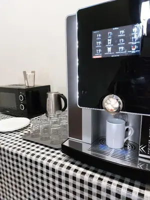 a black and white table with a coffee maker and cups at Cool room on Letná D1 in Prague