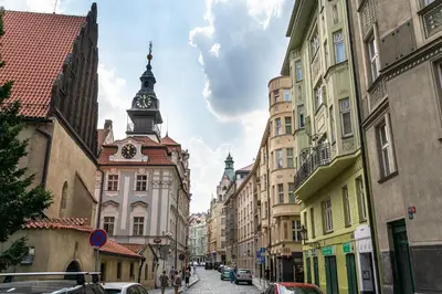 a city street with buildings and a clock tower at FAMILY 2 BEDROOM APARTMENT IN THE CITY CENTRE - by WISHLIST PRAGUE in Prague