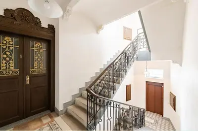 a hallway with a staircase and a wooden door at FAMILY 2 BEDROOM APARTMENT IN THE CITY CENTRE - by WISHLIST PRAGUE in Prague
