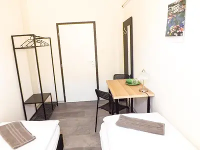a room with a table and chairs and a door at Letenský pokoj Milada E2 in Prague