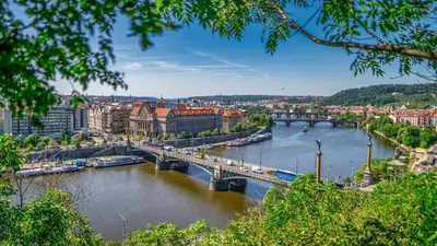 a view of a river with a bridge and buildings at Nice room E3 Prague 7 in Prague