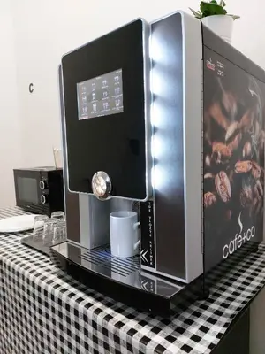 a coffeemaker sitting on top of a table at Ubytování E4 Praha Letná in Prague