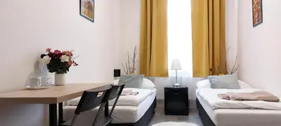 a living room with a table and a couch at Ubytování E4 Praha Letná in Prague