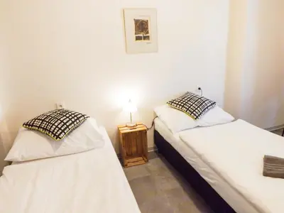 two twin beds in a room with a lamp at Classic room E5 Prague centre in Prague