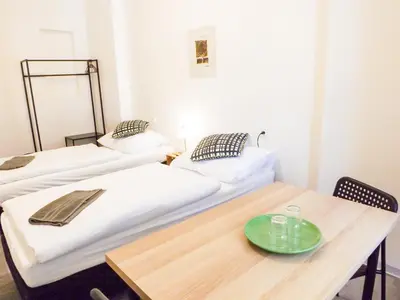 a room with two beds and a table with a plate on it at Classic room E5 Prague centre in Prague