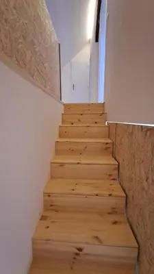 a staircase in a house with wooden floors at Prague Panorama Loft in Prague