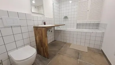 a bathroom with a toilet and a sink and a tub at Prague Panorama Loft in Prague