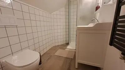 a bathroom with a toilet and a sink at Prague Panorama Loft in Prague