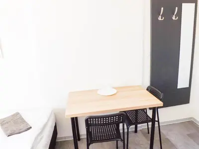 a small room with a table and two chairs at Prague room Letná H2 in Prague