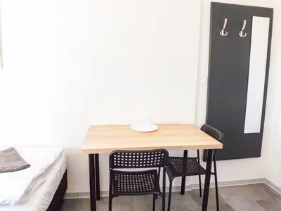 a small table and chairs in a room with a bed at Prague room Letná H2 in Prague