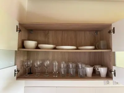 a cupboard with glasses and bowls on it at Glamping Prokop in Prague