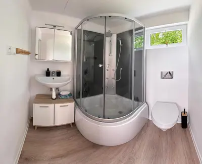 a bathroom with a shower and a sink at Glamping Prokop in Prague